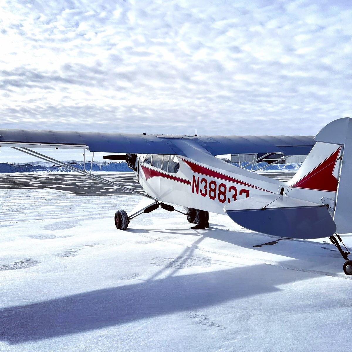 Cessna N38837 on the snow-covered ramp at S25